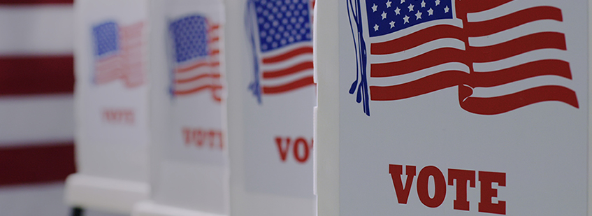 image of voting booth setting showing U.S. flags