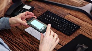 image of a woman making a mobile deposit with a smartphone